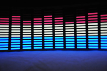 Light panel of pixels, neon with blue or green, yellow and red, a bright equalizer on a white...