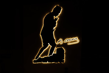 Silhouette of Ataturk (Mustafa Kemal Ataturk), founder of Republic Of Turkey  and his signature was illuminated with neon lamps over wall.