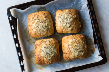 Freshly Baked Square Garlic Bread with Cheese and Herbs in Oven Tray.