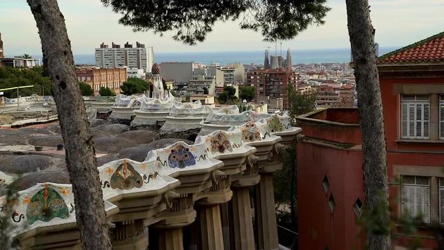 The Gaudi benches at Park Guell overlook the Sagrada Familia in Barcelona, Spain.
