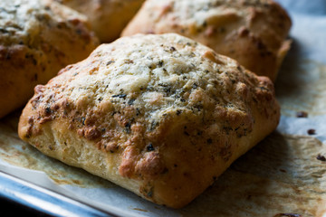Freshly Baked Square Garlic Bread with Cheese and Herbs in Oven Tray.