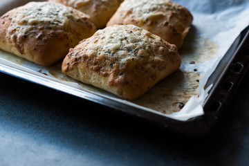 Freshly Baked Square Garlic Bread with Cheese and Herbs in Oven Tray.
