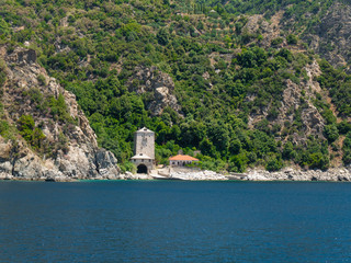 Fototapeta na wymiar monastery buildings on shore of the Aegean Sea. Greece, Athos