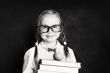 Back to school concept. Black and white portrait of cute child girl