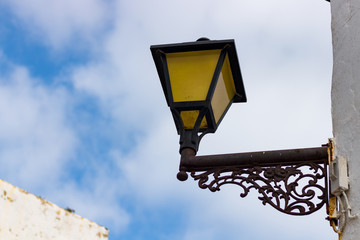 Fototapeta na wymiar Yellow lamppost under the blue sky
