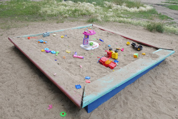 Sandbox with scattered children's toys