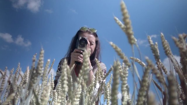 A woman shoots with an 8mm camera.