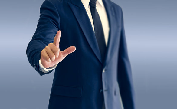 A businessman is standing and pointing hand.