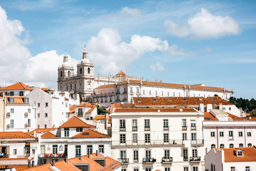 Fototapeta na wymiar Beautiful view of Lisbon in Portugal. One of the most beautiful cities in Europe. Traditional houses with yellow roofs against the blue sky.