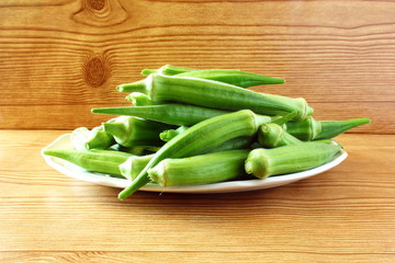 fresh okra vegetable in wooden table background