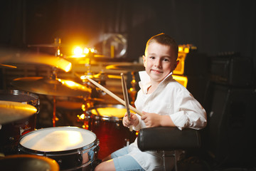 Fototapeta na wymiar boy plays drums in recording studio