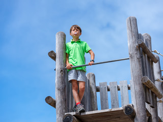 Child crossing a bridge of ropes