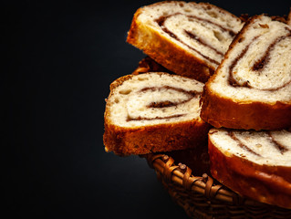 fresh appetizing strudel with cinnamon on a black background