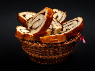 fresh appetizing strudel with cinnamon on a black background