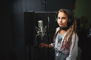 little girl singing in recording studio