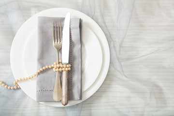 Wedding table place setting with plates, fork and knife, top view