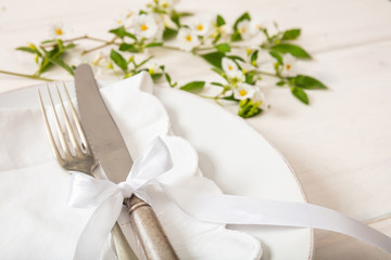 Holiday table place setting with plates, fork and knife