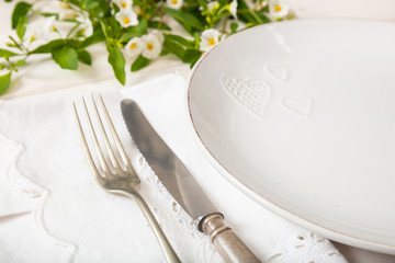 Holiday table place setting with plates, fork and knife