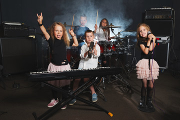 happy children singing and playing music