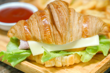 Croissant ham cheese delicious breakfast on wooden table