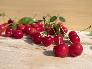 fresh cherry group with leaves on wooden table