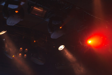 Red stage lights, strong spot beams in smoke