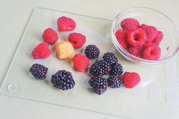 Summer berries, raspberries and garden blackberries.View from above,  candid.