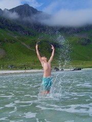Boy splashing in a cold Norwegian sea