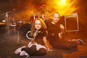 boy and girl singing in recording studio