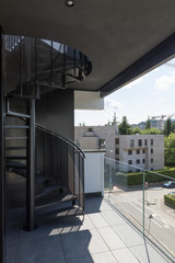 Fototapeta premium External spiral staircase in the private apartment on the top floor, nobody