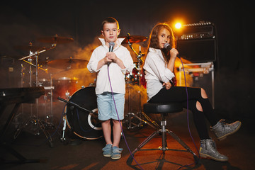 boy and girl singing in recording studio