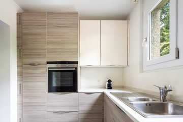 Modern kitchen with wood and a window where a lot of light enters