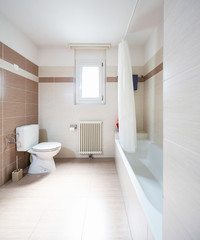 Fototapeta na wymiar Spacious and bright bathroom with tiles