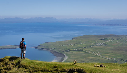 Man Standing at Cliff on Quiraing Trail in Summer Skye Scotland UK