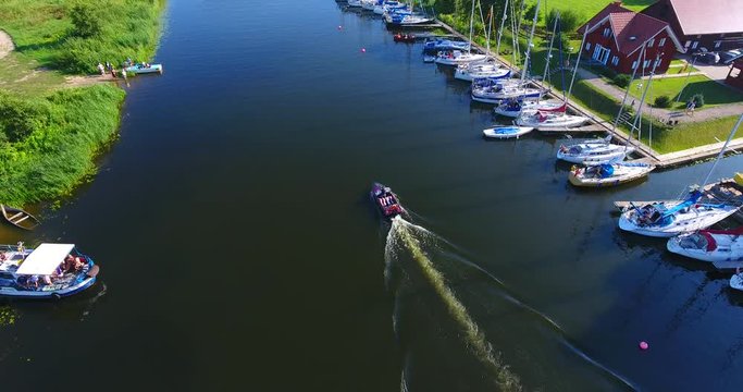 Flight over a rural landscape river following a boat driving - 14