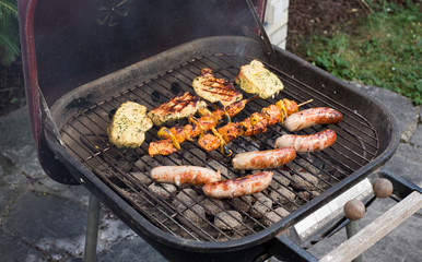 Meat on barbecue in yard