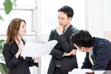 3名の会議・真剣・紙の資料