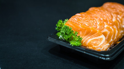 Salmon raw sashimi on black table, japanese food Closed up.