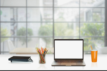 Mock up : Workspace with blank white desktop computer, pencils and stationery items. Blank screen for graphics display montage