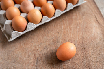 Fresh chicken eggs eggs in paper tray,egg carton on wooden background.
