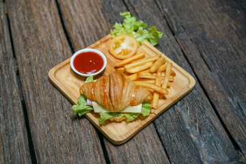 Croissant ham cheese delicious breakfast on wooden table