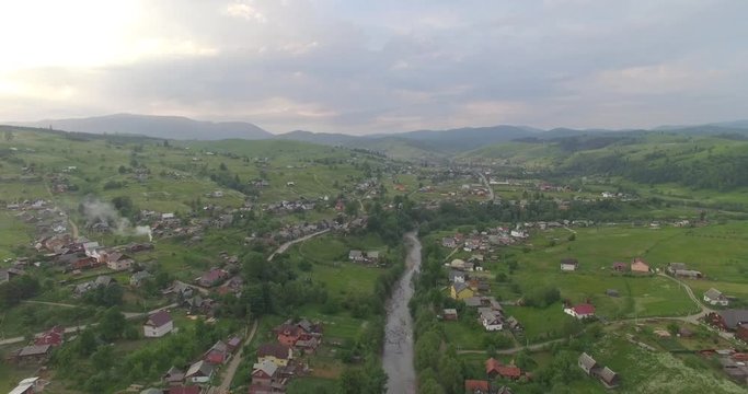 Aerial Sunset View Green Grass Summer Mountain. Sunset In Mountains. View of Carpathians Mountains In Sunrise. Green Mountain At Spring In Sunset.Drone Aerial View On Mountain Valley Top.