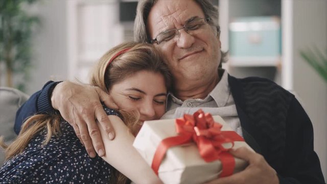 Young daughter gives her father a gift