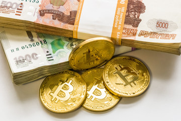 bitcoin gold and the Russian ruble. Bitcoin coin on the background of Russian rubles.