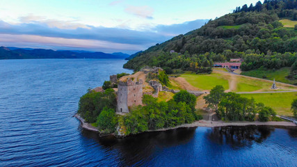 Fototapeta premium Urquhart Castle and Loch Ness in the evening - aerial drone view