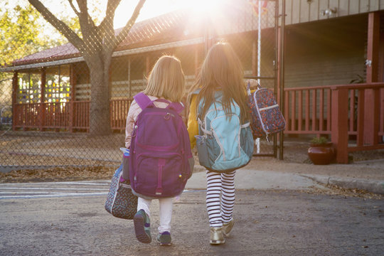 Two sisters outside their school before classes begin.