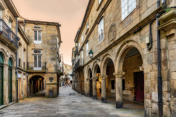 View of Santiago de Compostela old town street and buildings at sunset.