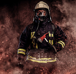 A firefighter dressed in a uniform in a studio.