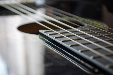 Fototapeta premium Detail of classic acoustic guitar with shallow DOF and blur.