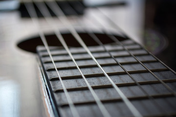 Fototapeta premium Detail of classic acoustic guitar with shallow DOF and blur.